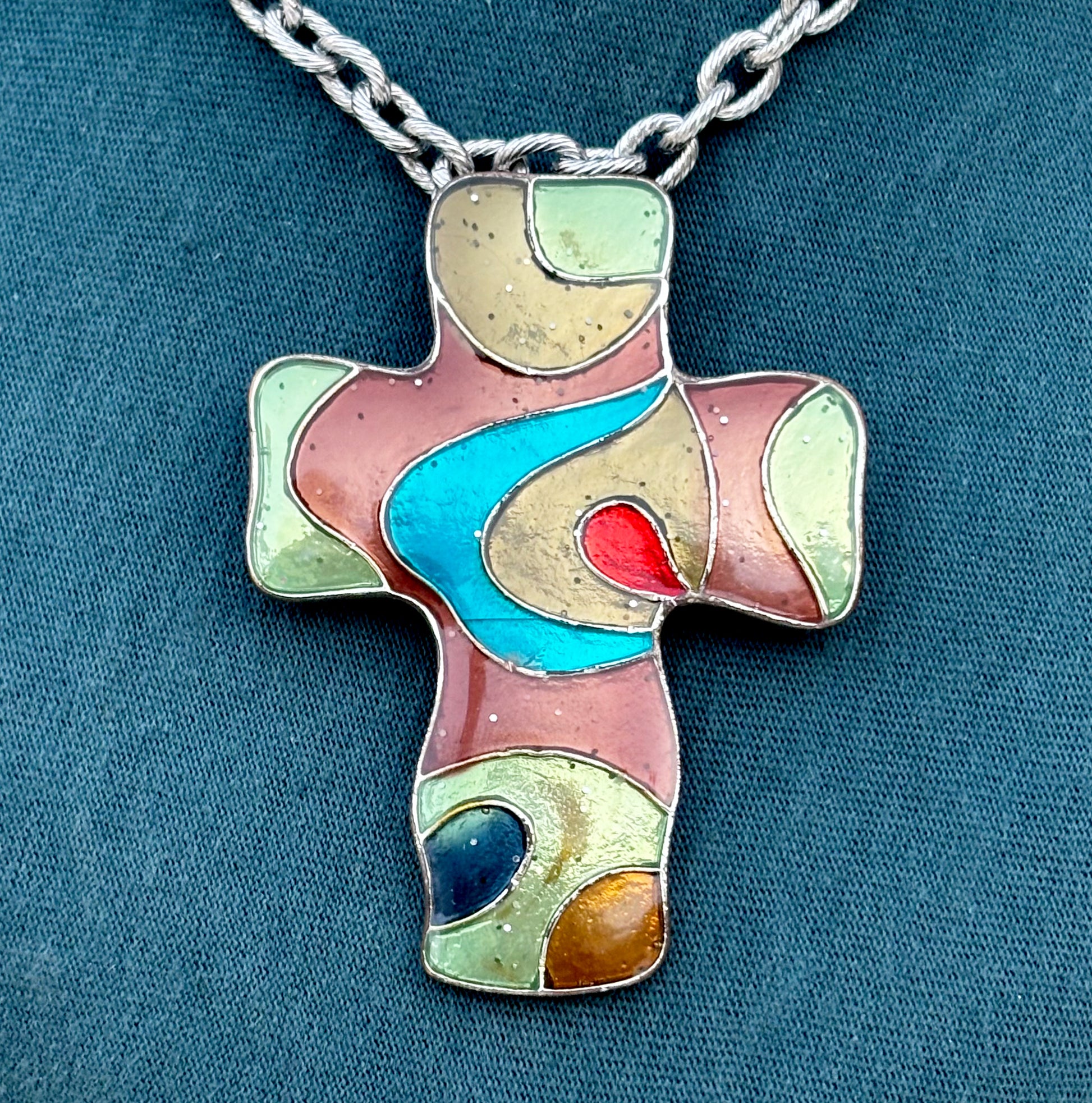 Vintage handcrafted cross pendant with flowing abstract color composition.
Stainless steel chain.
One-of-a-kind wearable artwork.